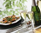 Glasses of sparkling wine, wine bottle, stuffed courgettes