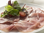Various types of Italian ham with salad garnish