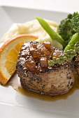 Peppered pork tenderloin in orange sauce