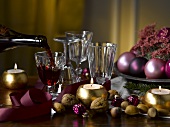 Table with Christmas decorations and red wine