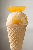 Orange ice cream in wafer cone