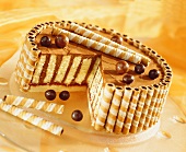 Chocolate cream cake with wafer rolls