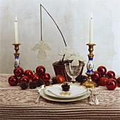 Red baubles and felt angels on Christmas table