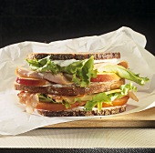 Double-decker turkey, bacon and cheese sandwich