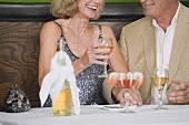 Mature couple with wine and shrimps in restaurant