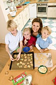 Mother and three children baking biscuits