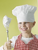 Girl in chef's hat and apron with beater