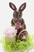 A chocolate Easter Bunny with Easter egg and gift