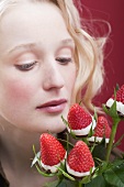 Young woman with bouquet of chocolate-dipped strawberries