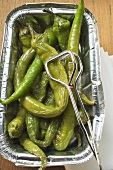 Pickled green chillies in aluminium tray