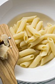Penne rigate, cheese plane and Parmesan
