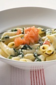 Penne rigate with spinach and cream sauce and diced tomato