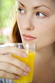 Young woman drinking orange juice