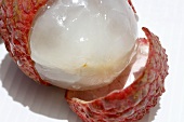 A half-peeled lychee