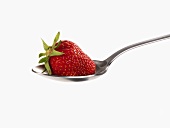 A strawberry on a spoon