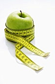 A green apple with a tape measure