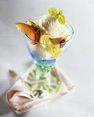 Vanilla ice cream with fruit & lemon balm in a sundae glass