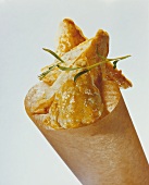 Small puff pastries in paper cone