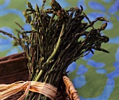 A bundle of green asparagus in a basket