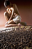 Young woman with coffee beans