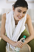 Young woman with mineral water after a workout