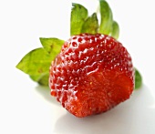 A strawberry with a bite taken