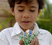 Boy holding an Easter egg in his hand