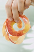 Hand hält Apfelschale
