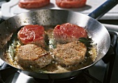 Frying veal medallions in a frying pan