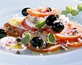 Tomatoes with mozzarella, capers and olives