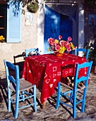 Table and blue chairs on a terrace