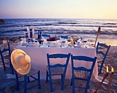 Laid table on the beach at twilight