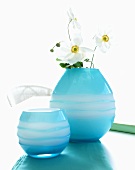 Blue glass vases one with white Japanese anemones