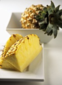 Pieces of pineapple and whole pineapple