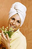 Woman in bathroom with bunch of chamomile