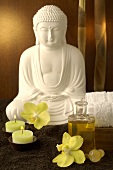 Buddha with orchid flowers and candles