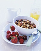 A bowl of muesli with almonds and fresh berries