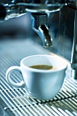 A cup of espresso on an espresso machine