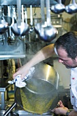 Chef emptying a pan