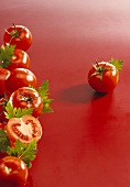Tomatoes and parsley against red background