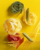 Various types of pasta on a yellow background
