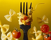Thin tagliatelle with tomatoes on a fork with farfalle