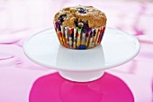 Blueberry Muffin with Colorful Wrapper on Pedestal Dish