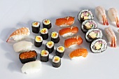 Various type of sushi on a white surface