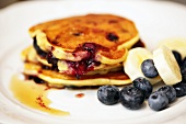 Pancakes with blueberreies, bananas and maple syrup