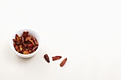 Dried chilli flakes in a bowl and next to it