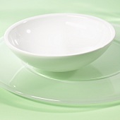 Small white bowl on a service plate