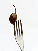 Olive speared on fork