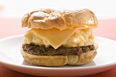 Cheeseburger with scrambled egg on plate