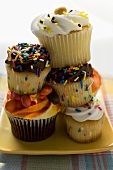 A pile of colourful decorated muffins